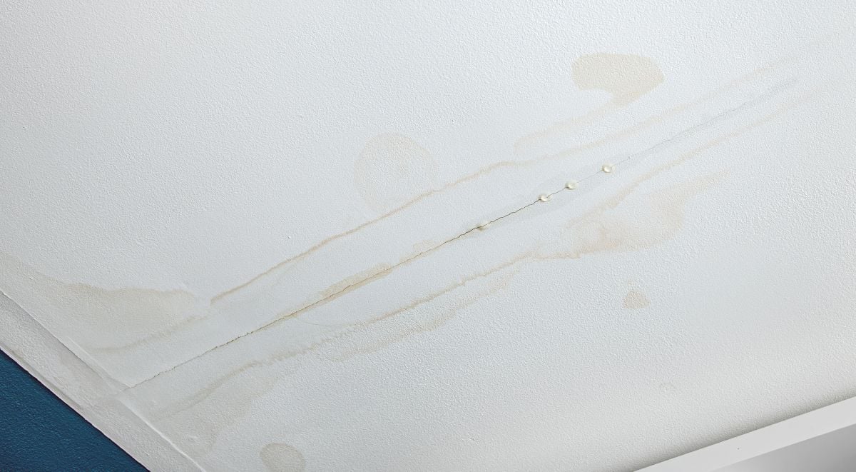 Water is leaking from drywall ceiling in home room, water damage